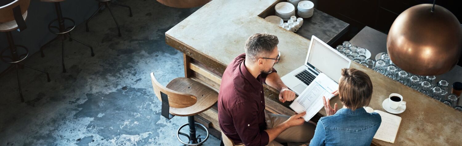 man and woman looking at report
